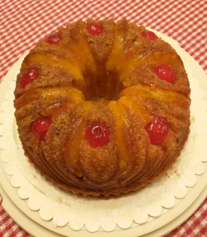 Freshly baked pineapple bundt cake with caramelized pineapple and cherries